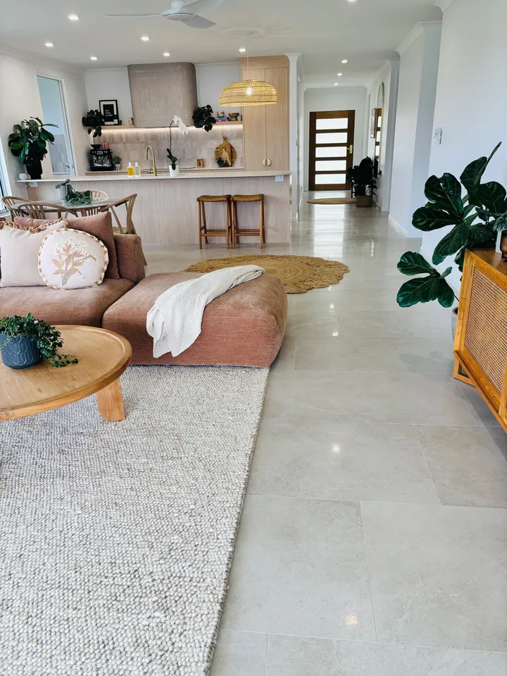 Living room and kitchen with large-format light floor tiles
